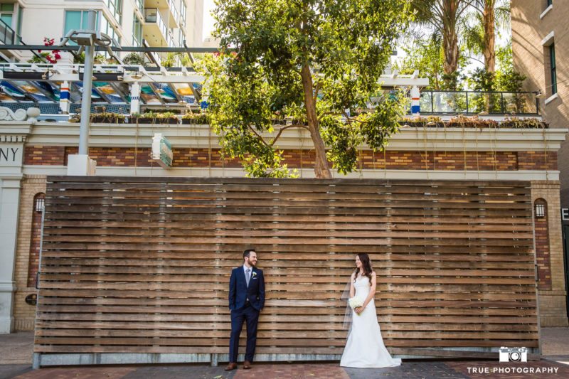 Bride and Groom against wood wall at Petco park