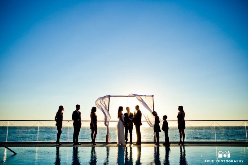 Ceremony by the water against the sunset