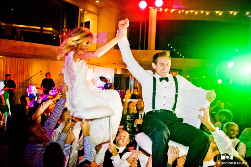 Bride and groom have fun with the hora