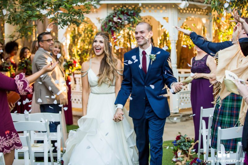 Bride and Groom celebrate and walk down aisle after first kiss