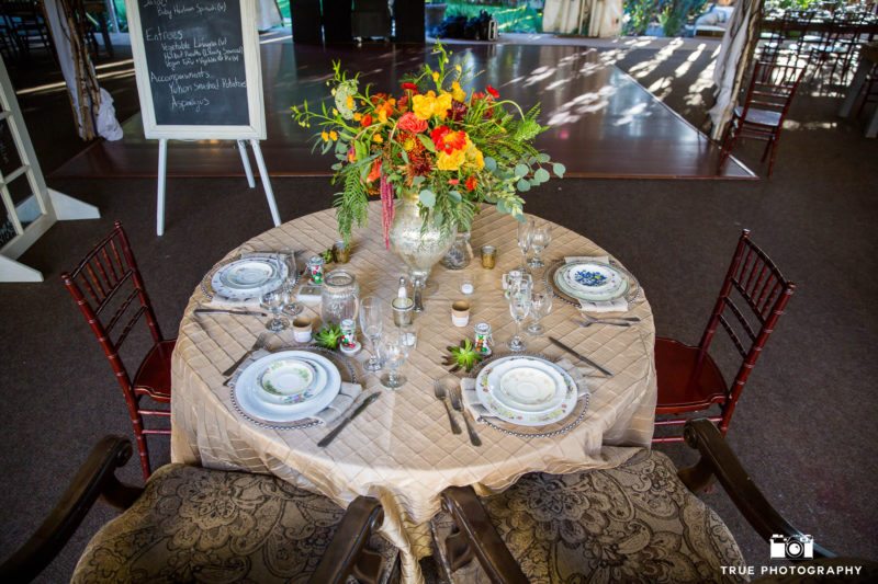 Bohemian-inspired sweetheart table at rustic wedding venue