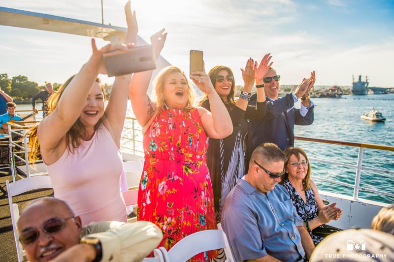 Guests applauding on a boat ceremony