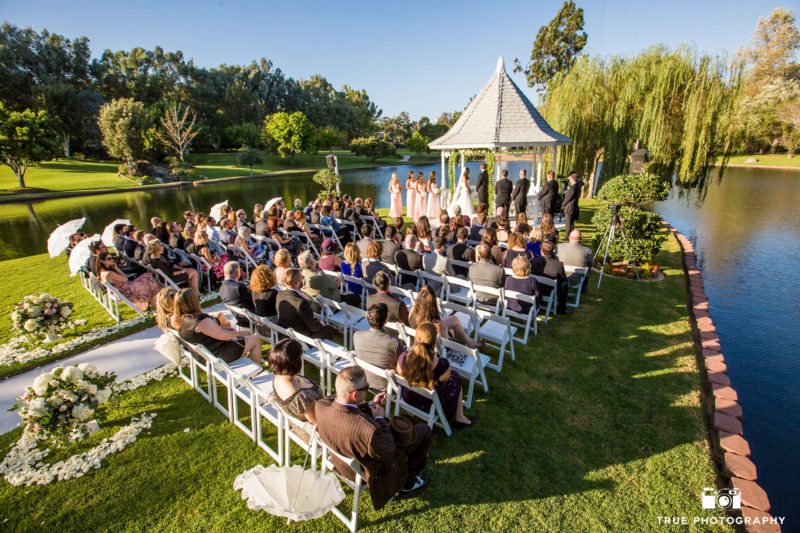 Outdoor wedding ceremony by pond