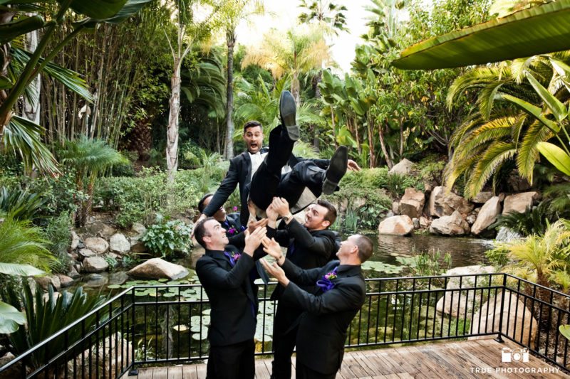 Groomsmen pick up the groom for a fun groomsmen shot