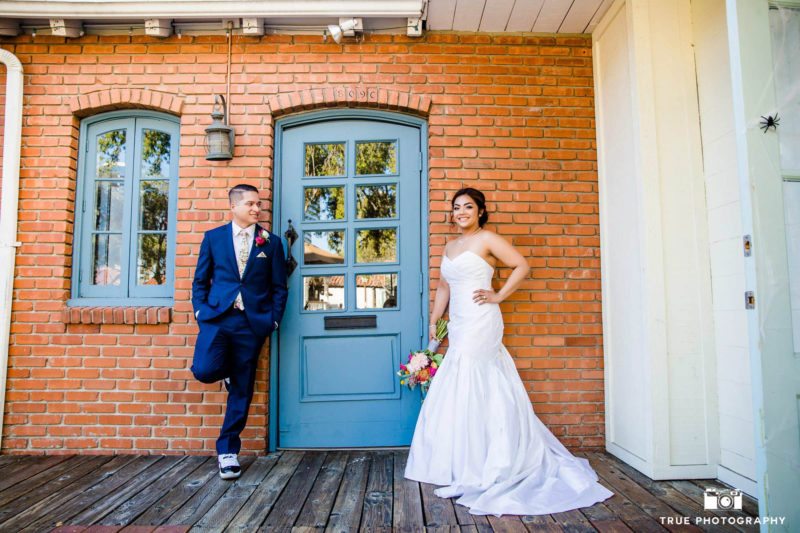 Newlyweds next to blue door