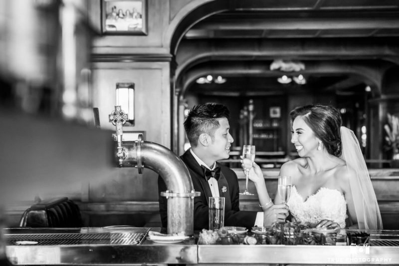Bride and Groom drinking champagne at bar in Downtown San Diego