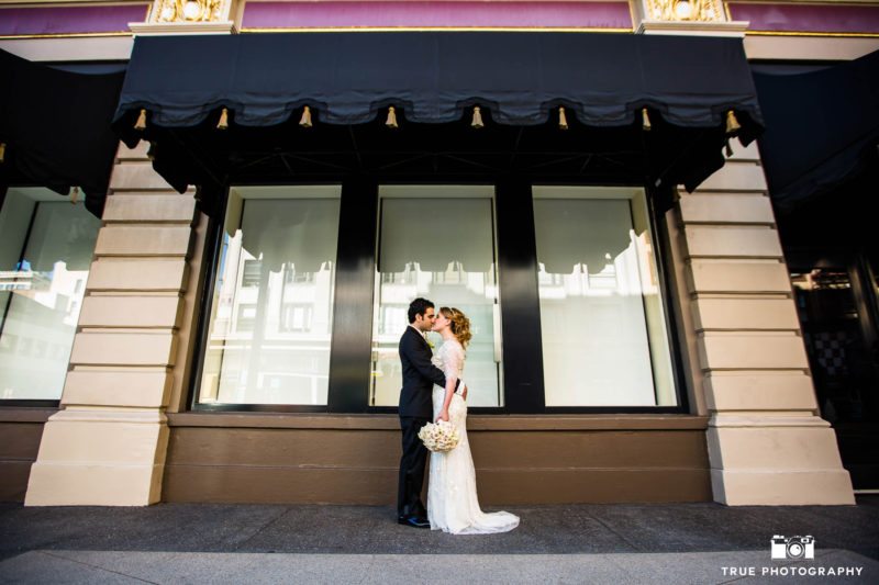 Bride and Groom kiss on streets of Downtown San Diego