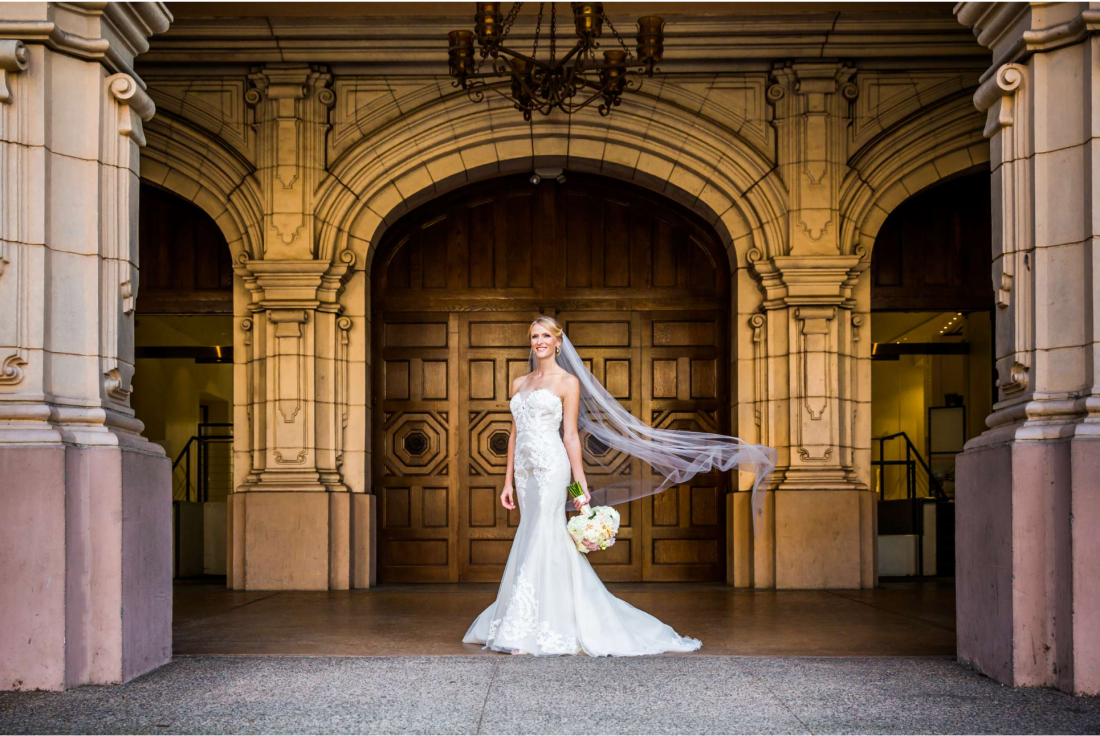 Bride framed by Balboa Park architecture photographed by True Photography