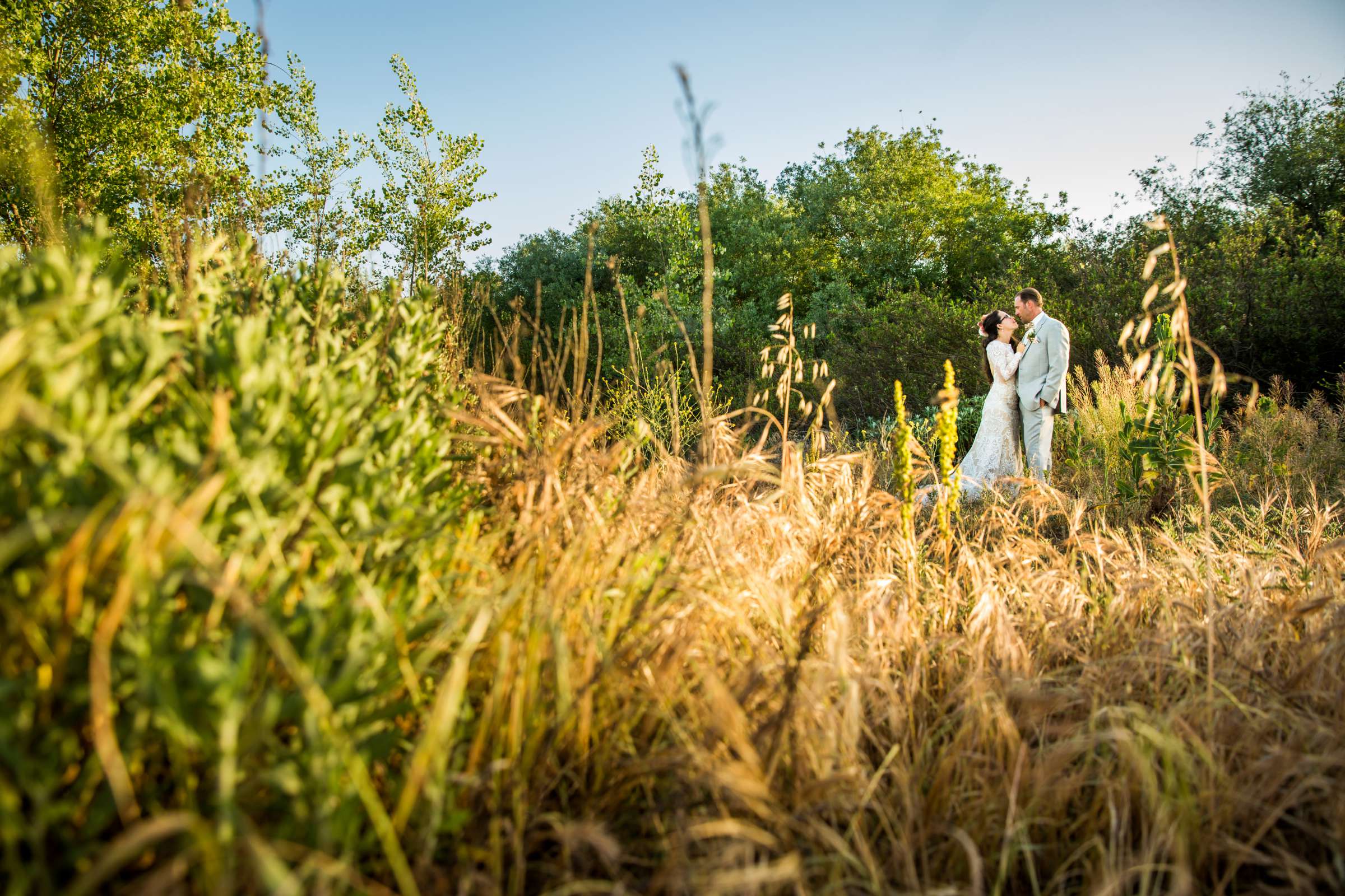 In a Field, Bride and Groom, Stylized Portrait at Rancho Guajome Adobe Wedding coordinated by Selina Rose Weddings & Events, Leticia and Anthony Wedding Photo #3 by True Photography